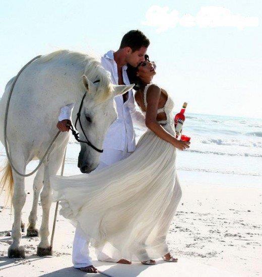Horse and couple on the beach